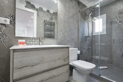 a bathroom with a sink and a toilet and a shower at BBarcelona El Carmel Apartment with terrace in Barcelona