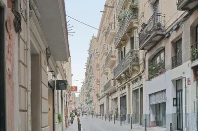 a narrow street with buildings on either side at My Space Barcelona - Newly renovated apartment in Gràcia for families and executives in Barcelona
