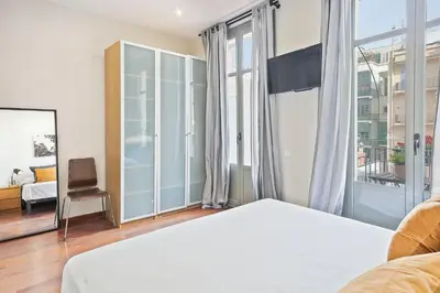 a bedroom with a bed and a large window at My Space Barcelona - Newly renovated apartment in Gràcia for families and executives in Barcelona