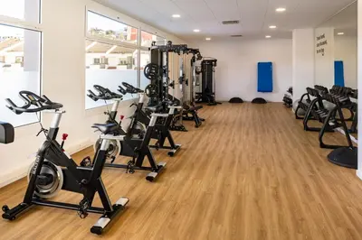 a gym with treadmills and exercise bikes in a room at htop Olympic #htopEnjoy in Calella