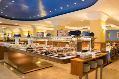 a buffet line with many different types of food at htop Pineda Palace 4Sup - Adults Only #htopBliss in Pineda de Mar