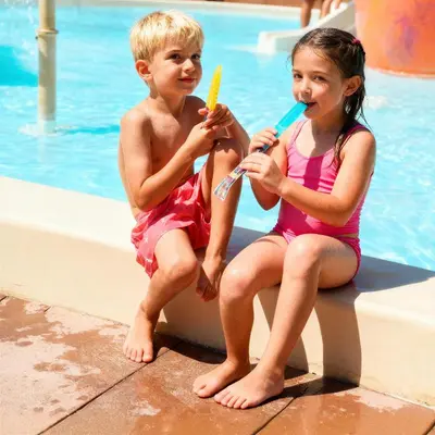 a boy and a girl brushing their teeth at a pool at htop Jadhe 4Sup #htopBliss in Calella