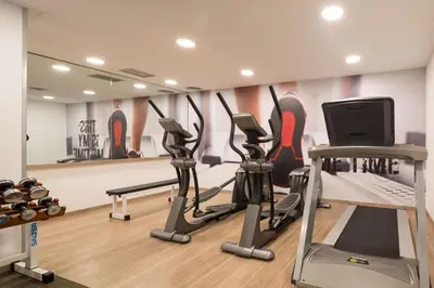 a gym with tread machines and a computer in a room at htop Amaika & SPA 4Sup - Adults Only #htopBliss in Calella