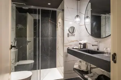 a bathroom with a shower and a sink and a toilet at Hotel Barcelona Catedral 4 Sup in Barcelona