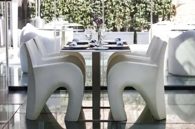 a white dining table and chairs in a restaurant at Olivia Plaza Hotel in Barcelona