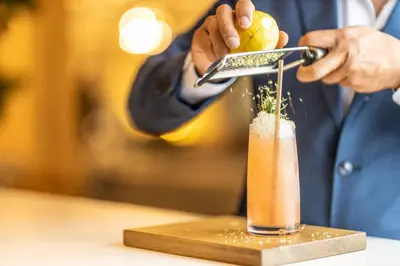 a man is preparing a drink on a table at Eurostars Sitges in Sitges
