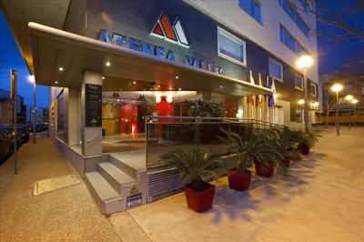 a store with potted plants in front of a building at Aparthotel Atenea Valles in Granollers