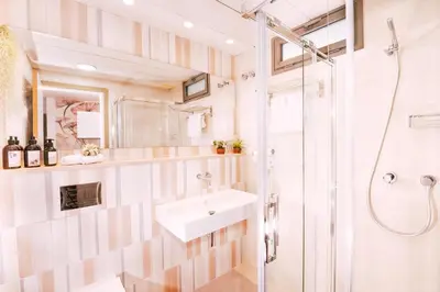 a bathroom with a sink and a shower at Apartamentos Marfina in Castelldefels