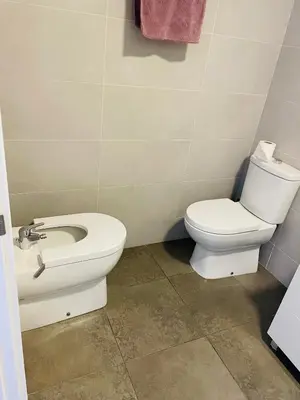 a bathroom with a toilet and a sink at Fira de Barcelona City View Apartment with Garage Parking in Hospitalet de Llobregat