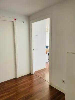 an empty room with white walls and wooden floors at Fira de Barcelona City View Apartment with Garage Parking in Hospitalet de Llobregat