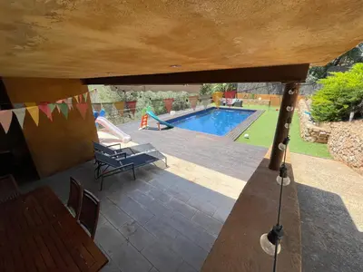 a view of a swimming pool from a house at Sunny forest Villa near Barcelona in Vallirana