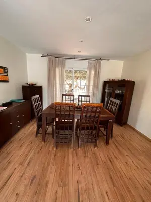 a dining room with a wooden table and chairs at Sunny forest Villa near Barcelona in Vallirana