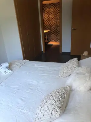 a white bed with two pillows on top of it at Standing Apartment Barcelona Forum in Sant Adria de Besos