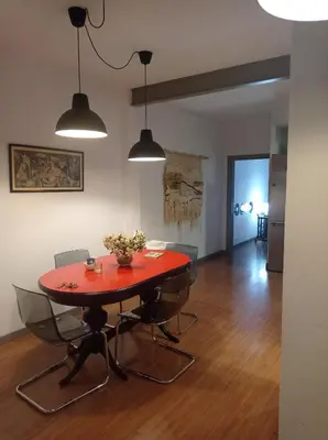 a dining room with a red table and chairs at SWEET APARTMENT IN GRACIA DISTRICT! in Barcelona