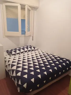 a black and white bed in a room with a window at SWEET APARTMENT IN GRACIA DISTRICT! in Barcelona