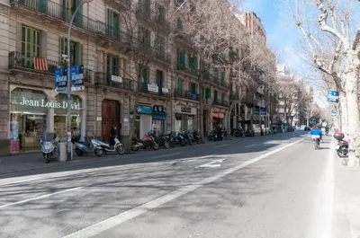 a person riding a bike down a city street at Homenfun Barcelona Eixample I in Barcelona