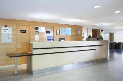 a lobby of a hospital with a reception desk at Holiday Inn Express Barcelona - Montmeló by IHG in Granollers
