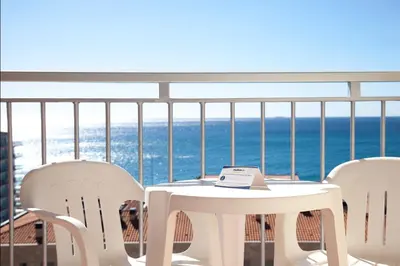a table and chairs on a balcony with the ocean at Medplaya Hotel Santa Monica in Calella