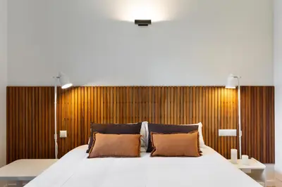 a bedroom with a large white bed with brown pillows at Señor Urgell Apartment by Olala Homes in Barcelona