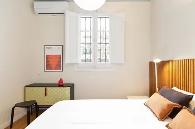 a bedroom with a white bed and a window at Señor Urgell Apartment by Olala Homes in Barcelona