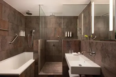 a bathroom with a tub and a sink and a bath tub at Le Meridien Barcelona in Barcelona