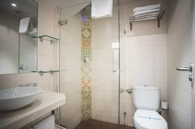 a bathroom with a shower and a toilet and a sink at Hostal Marenostrum in Barcelona