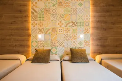 two white beds with pillows in front of a wall at Hostal Marenostrum in Barcelona