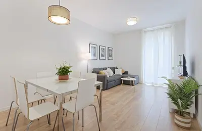 a dining room and living room with a table and chairs at CENTRAL & BRIGHT APARTMENT!! in Barcelona