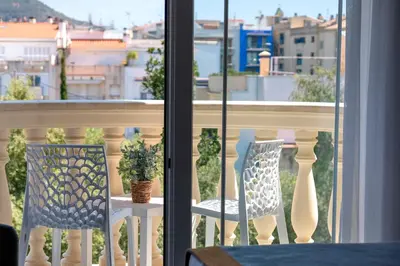 a table and two chairs on a balcony with a view at URH Sitges Playa in Sitges
