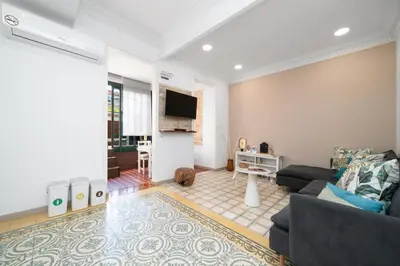 a living room with a couch and a tv at Bright Apt with Private Terrace in Sant Antoni in Barcelona