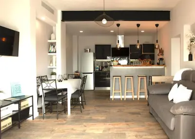 a living room and kitchen with a couch and a table at Les Terrasses de la Cisa, 20kms de BCN in Premia de Dalt