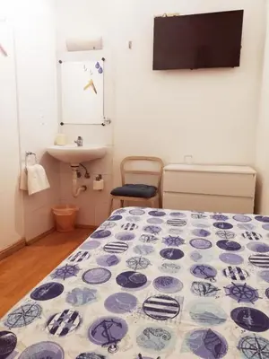 a room with a bed and a sink in a room at Hostal Felipe 2 in Barcelona