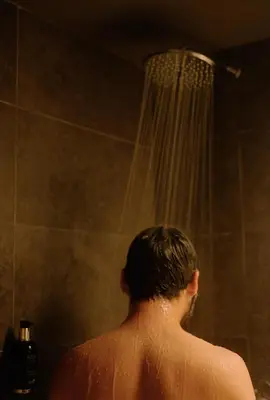 a man taking a shower in a bathroom at Pol & Grace Hotel in Barcelona
