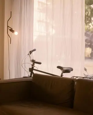 a bike sitting in a living room next to a window at Pol & Grace Hotel in Barcelona