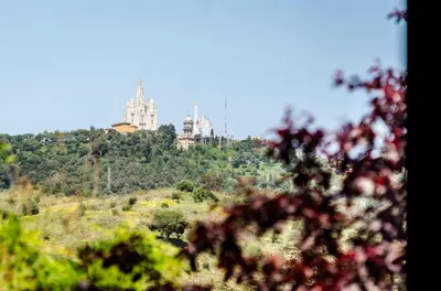 a castle on top of a hill with trees at Ikonik Anglí in Barcelona