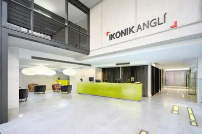 a lobby with a green counter in a building at Ikonik Anglí in Barcelona