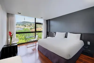 a bedroom with a large white bed and a large window at Ikonik Anglí in Barcelona