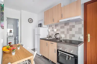a kitchen with a table and a counter top at Magic Badalona House in Badalona