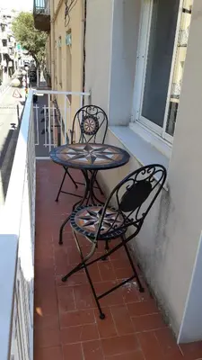 two chairs and a table on a balcony at Magic Badalona House in Badalona