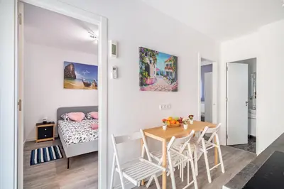 a room with a table and chairs and a bedroom at Magic Badalona House in Badalona