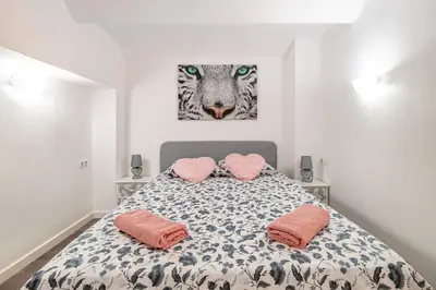 a bedroom with a bed with two pink pillows at Magic Badalona House in Badalona