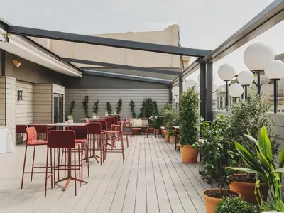 a patio with chairs and tables and plants at Catalonia Boulevard in Barcelona