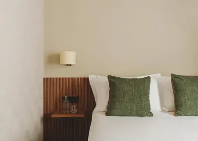 a bedroom with a bed with green and white pillows at Catalonia Boulevard in Barcelona