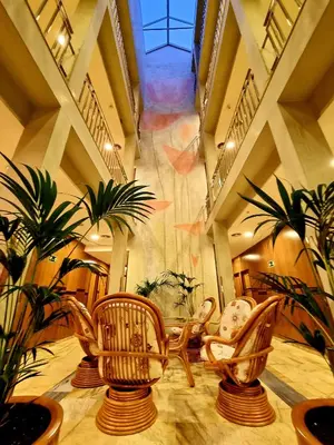 a room with chairs and plants in a building at Flor Parks in Barcelona