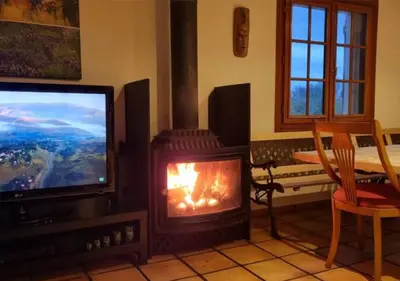 a living room with a fireplace and a television at Casa Donaire in Marganell