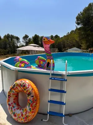 a donut sitting on a boat next to a pool at VILLA CHETRUS Casa en plena naturaleza in Rubí