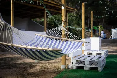 a blue and white hammock sitting next to a bench at VILLA CHETRUS Casa en plena naturaleza in Rubí