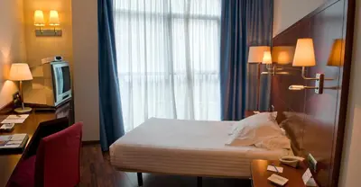 a hotel room with a bed and a window at Best Western Hotel Mediterraneo in Castelldefels