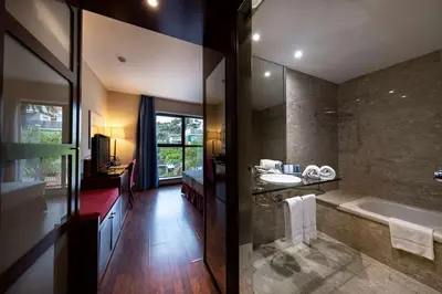 a bathroom with a tub and a sink and a bath tub at Best Western Hotel Mediterraneo in Castelldefels