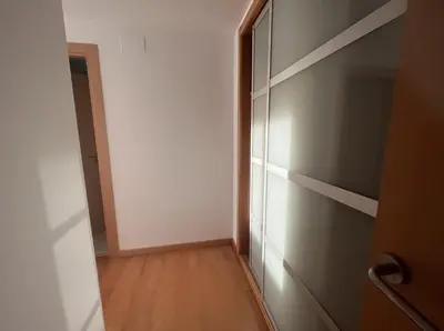 an empty hallway with a closet and a wooden floor at Beach & Culture Barcelona Port Forum Penthouse Apartment in Sant Adria de Besos